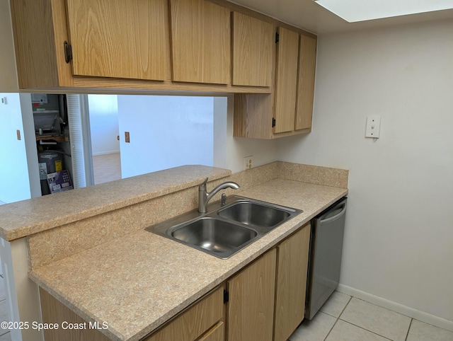 kitchen featuring light tile patterned flooring, dishwasher, light countertops, and a sink