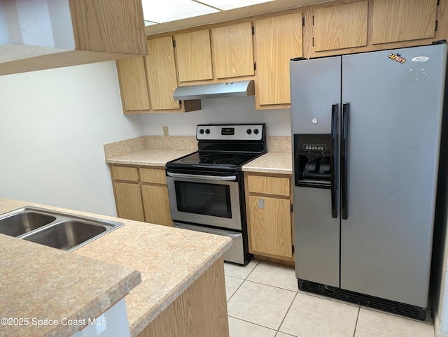 kitchen featuring under cabinet range hood, light tile patterned floors, light countertops, and appliances with stainless steel finishes