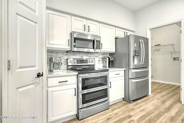 4026 Four Lakes Dr, Melbourne, FL 32940 - kitchen featuring light countertops, appliances with stainless steel finishes, and white cabinets
