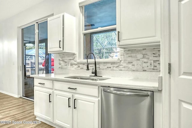 4026 Four Lakes Dr, Melbourne, FL 32940 - kitchen with stainless steel dishwasher, white cabinetry, and a sink
