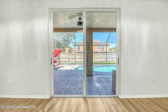 4026 Four Lakes Dr, Melbourne, FL 32940 - doorway to outside featuring baseboards, wood finished floors, and a ceiling fan