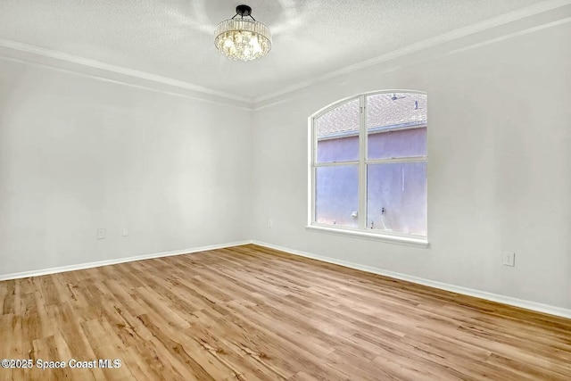 4026 Four Lakes Dr, Melbourne, FL 32940 - empty room featuring plenty of natural light, a chandelier, and wood finished floors