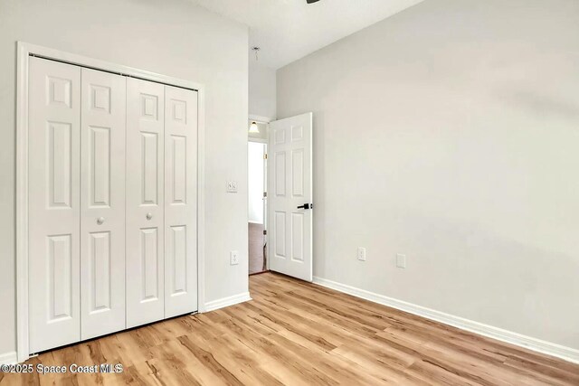 4026 Four Lakes Dr, Melbourne, FL 32940 - unfurnished bedroom featuring a closet, baseboards, and light wood finished floors
