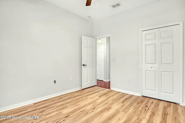 4026 Four Lakes Dr, Melbourne, FL 32940 - unfurnished bedroom with baseboards, light wood finished floors, visible vents, a ceiling fan, and a closet