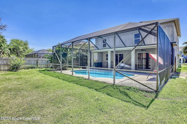 4026 Four Lakes Dr, Melbourne, FL 32940 - rear view of house with fence, a lanai, a ceiling fan, a lawn, and a patio area