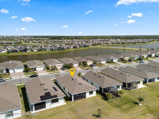 drone / aerial view featuring a residential view and a water view