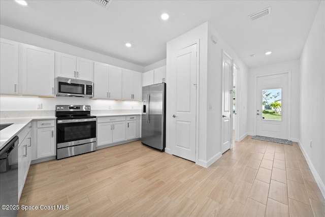 kitchen featuring light countertops, recessed lighting, visible vents, and appliances with stainless steel finishes