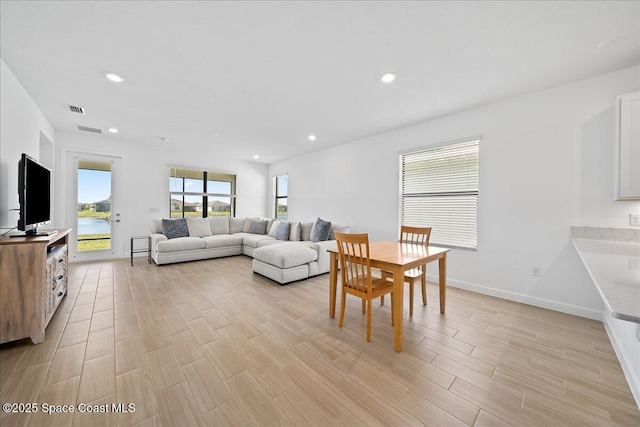 living room featuring visible vents, recessed lighting, light wood-type flooring, and baseboards