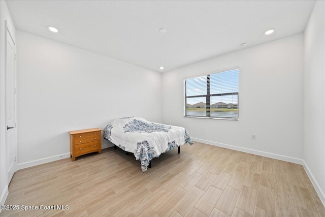 bedroom featuring recessed lighting, baseboards, and light wood-style floors