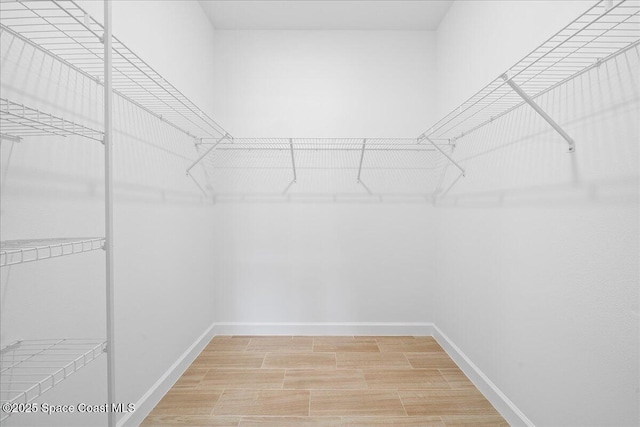 walk in closet featuring light wood-style flooring