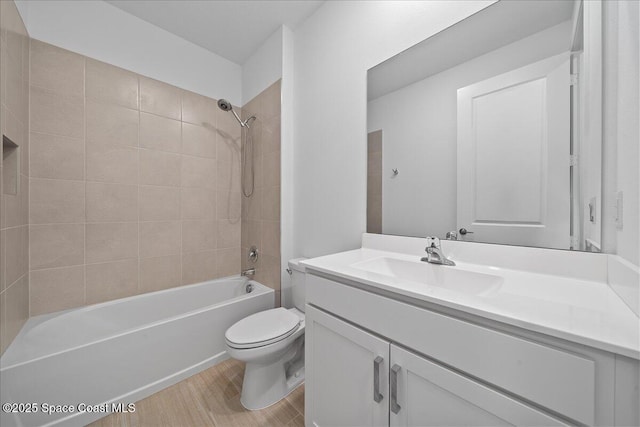 bathroom featuring vanity, shower / bathing tub combination, toilet, and wood finished floors