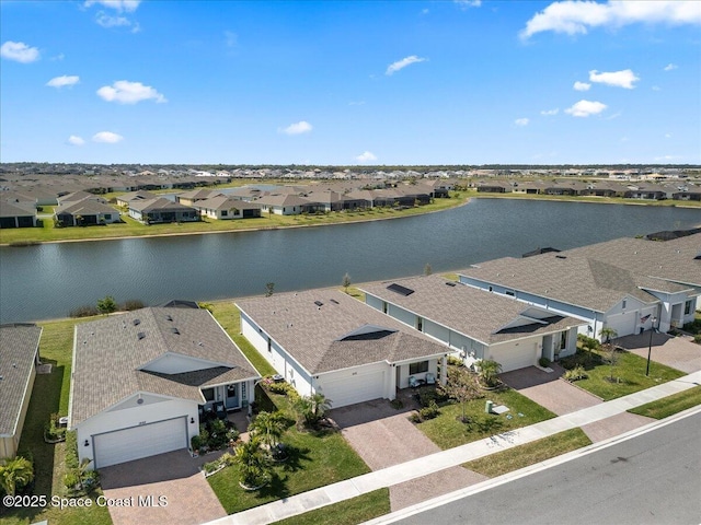 drone / aerial view with a residential view and a water view