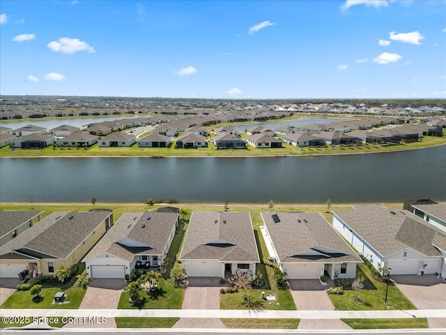 birds eye view of property with a residential view and a water view