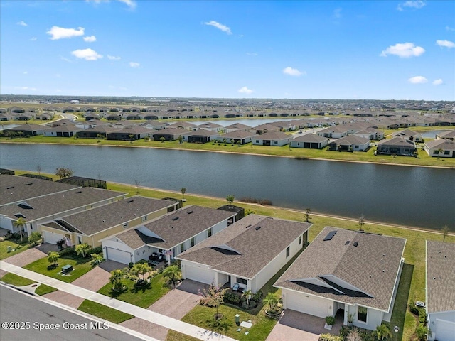 birds eye view of property with a residential view and a water view