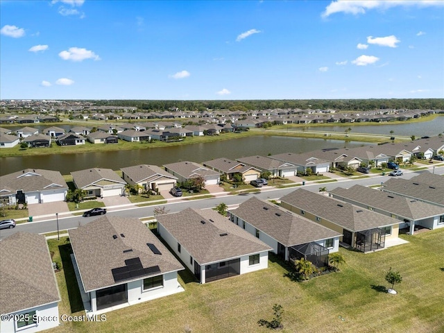 drone / aerial view with a residential view and a water view