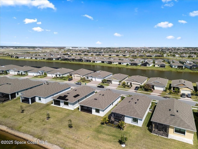 birds eye view of property with a residential view and a water view