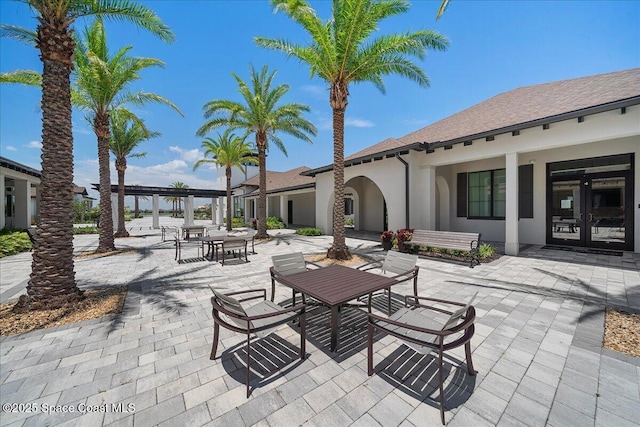 view of patio / terrace featuring outdoor dining space, french doors, and a pergola