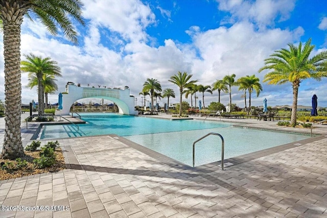 pool featuring a patio and a water slide