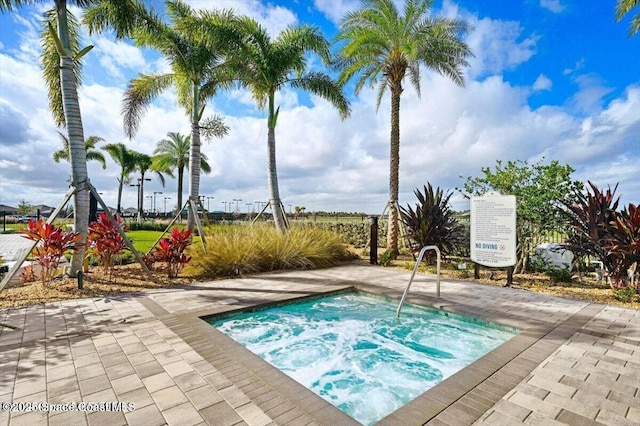 view of pool with a hot tub