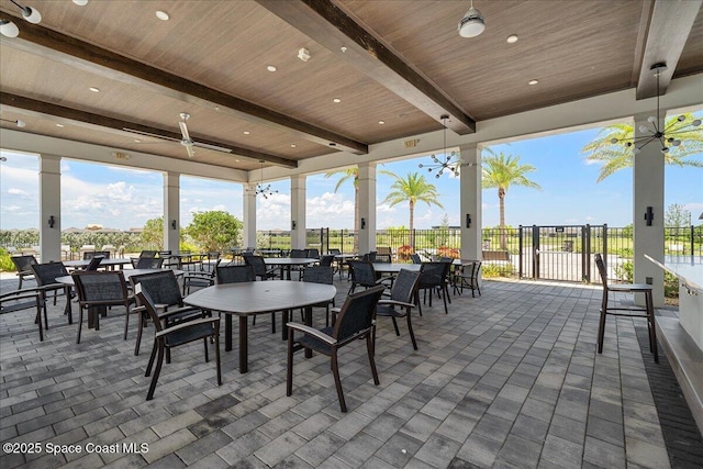 view of patio / terrace with outdoor dining area, fence, and ceiling fan