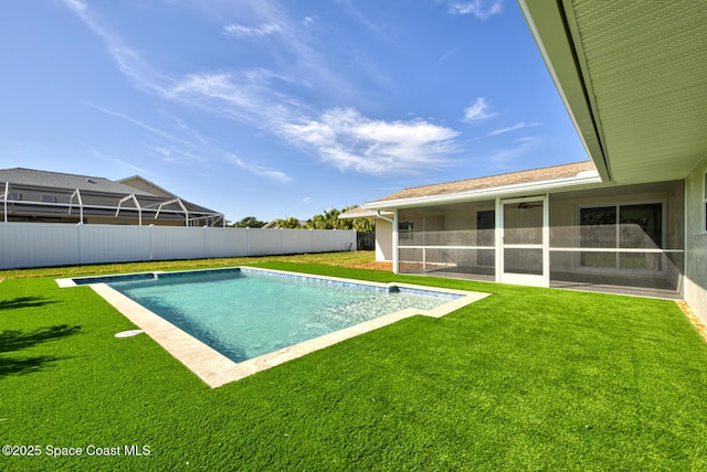 view of swimming pool with a yard, a fenced in pool, a fenced backyard, and a sunroom