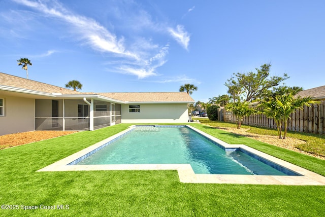 view of pool with a fenced in pool, a sunroom, a lawn, and fence