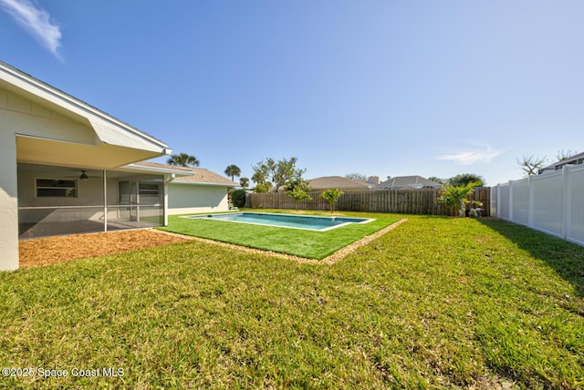 view of yard featuring a fenced in pool, a fenced backyard, and a sunroom