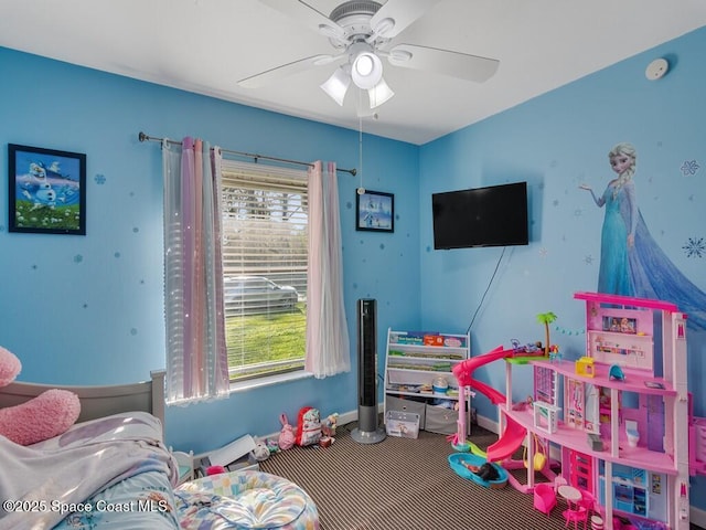 rec room featuring baseboards and ceiling fan