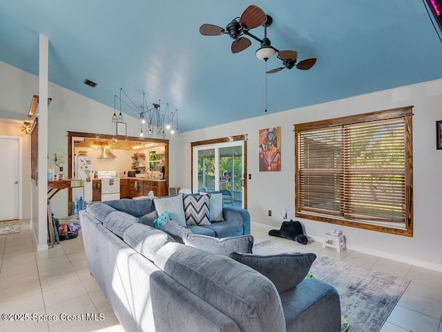 living room featuring lofted ceiling, light tile patterned floors, a ceiling fan, and visible vents