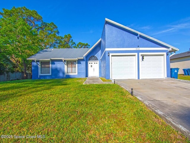 view of front of home featuring a front lawn, fence, stucco siding, a garage, and driveway