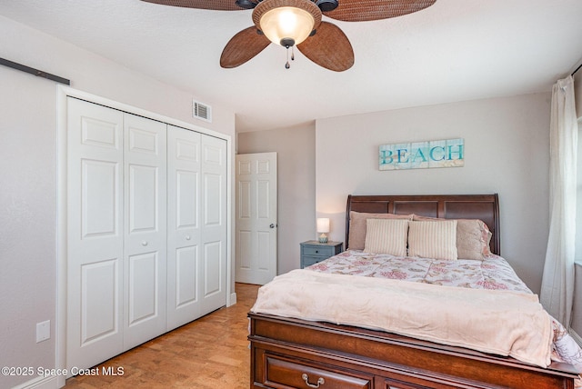 bedroom with visible vents, a closet, and ceiling fan