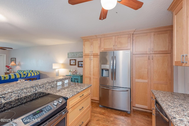 kitchen featuring ceiling fan, light brown cabinets, and stainless steel appliances