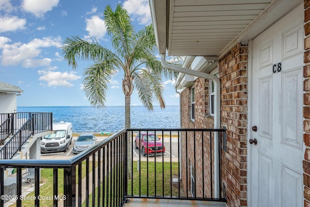 balcony featuring a water view