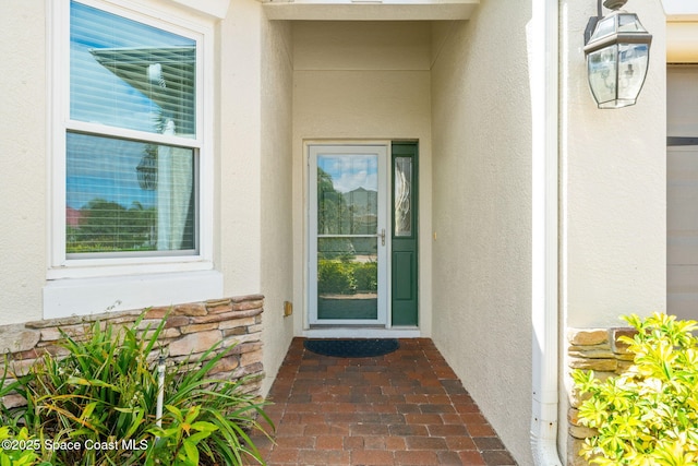3980 Funston Cir, Melbourne, FL 32940 - doorway to property with stucco siding and stone siding