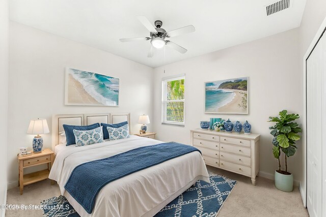 3980 Funston Cir, Melbourne, FL 32940 - bedroom with baseboards, light carpet, visible vents, and a ceiling fan