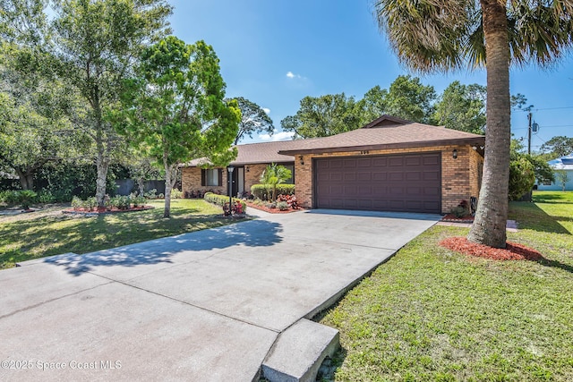 ranch-style home featuring roof with shingles, a front yard, brick siding, a garage, and driveway