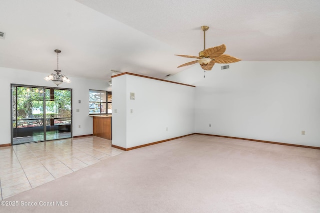 unfurnished living room with baseboards, visible vents, lofted ceiling, light colored carpet, and ceiling fan with notable chandelier