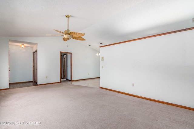 empty room with ceiling fan, light colored carpet, baseboards, and lofted ceiling