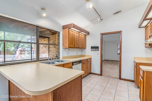 kitchen featuring a peninsula, visible vents, light countertops, a sink, and white dishwasher
