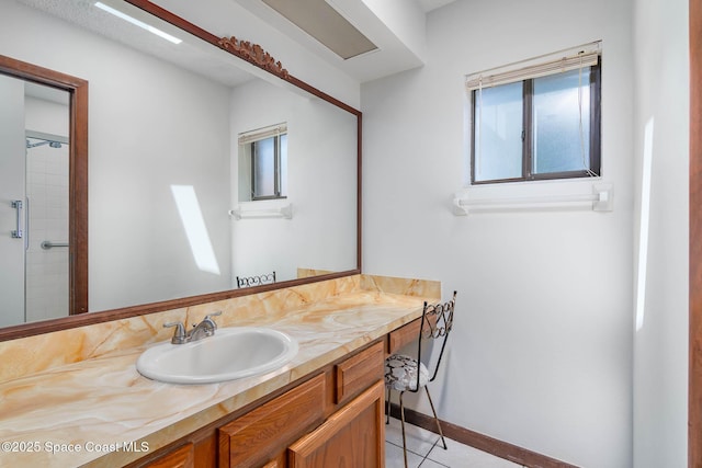 bathroom with tile patterned floors, vanity, and baseboards