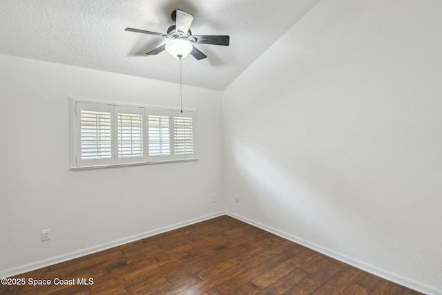 empty room with dark wood-type flooring, a textured ceiling, baseboards, and ceiling fan