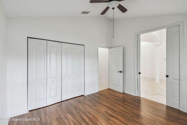 unfurnished bedroom featuring a ceiling fan, wood finished floors, a closet, baseboards, and visible vents
