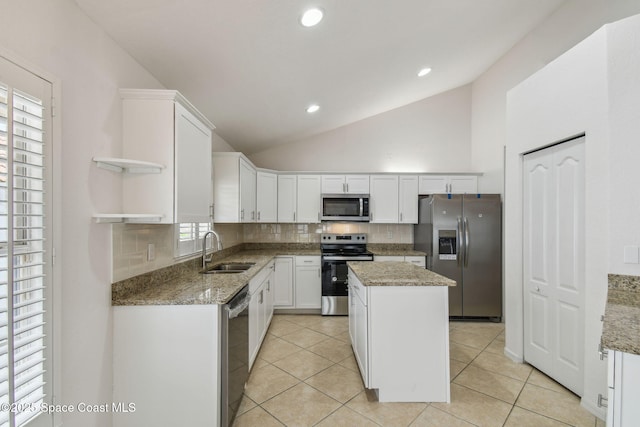 kitchen with white cabinets, a sink, tasteful backsplash, open shelves, and appliances with stainless steel finishes