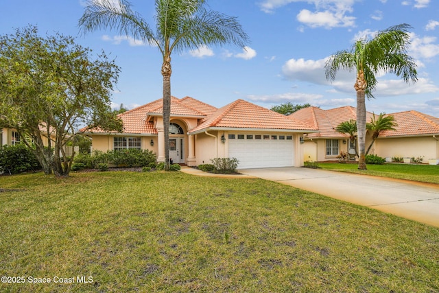 mediterranean / spanish-style home with concrete driveway, a front lawn, a tiled roof, a garage, and stucco siding