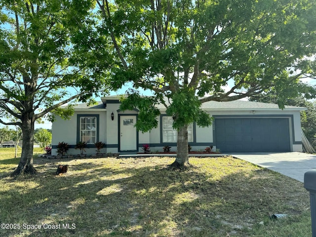 ranch-style house with concrete driveway, an attached garage, and stucco siding