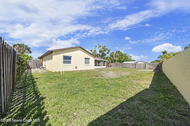 view of yard featuring central air condition unit and a fenced backyard