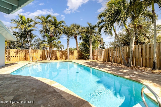 view of swimming pool featuring a fenced in pool, a fenced backyard, and a patio area