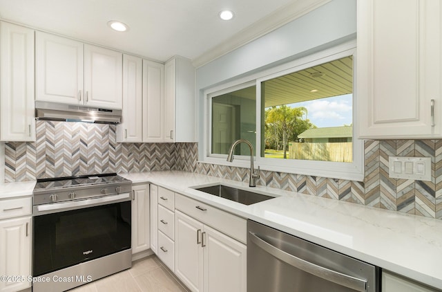 kitchen featuring under cabinet range hood, appliances with stainless steel finishes, white cabinets, and a sink