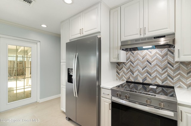 kitchen with under cabinet range hood, stainless steel appliances, light countertops, and tasteful backsplash