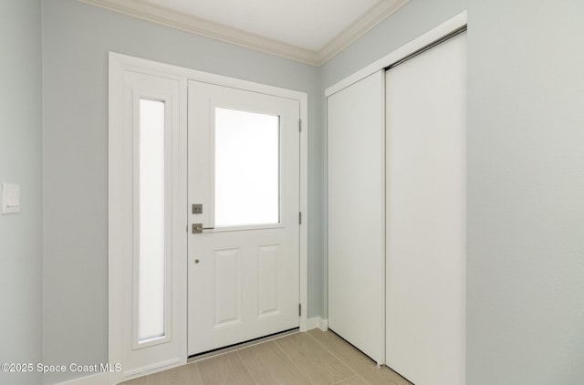 entryway featuring wood finish floors and ornamental molding